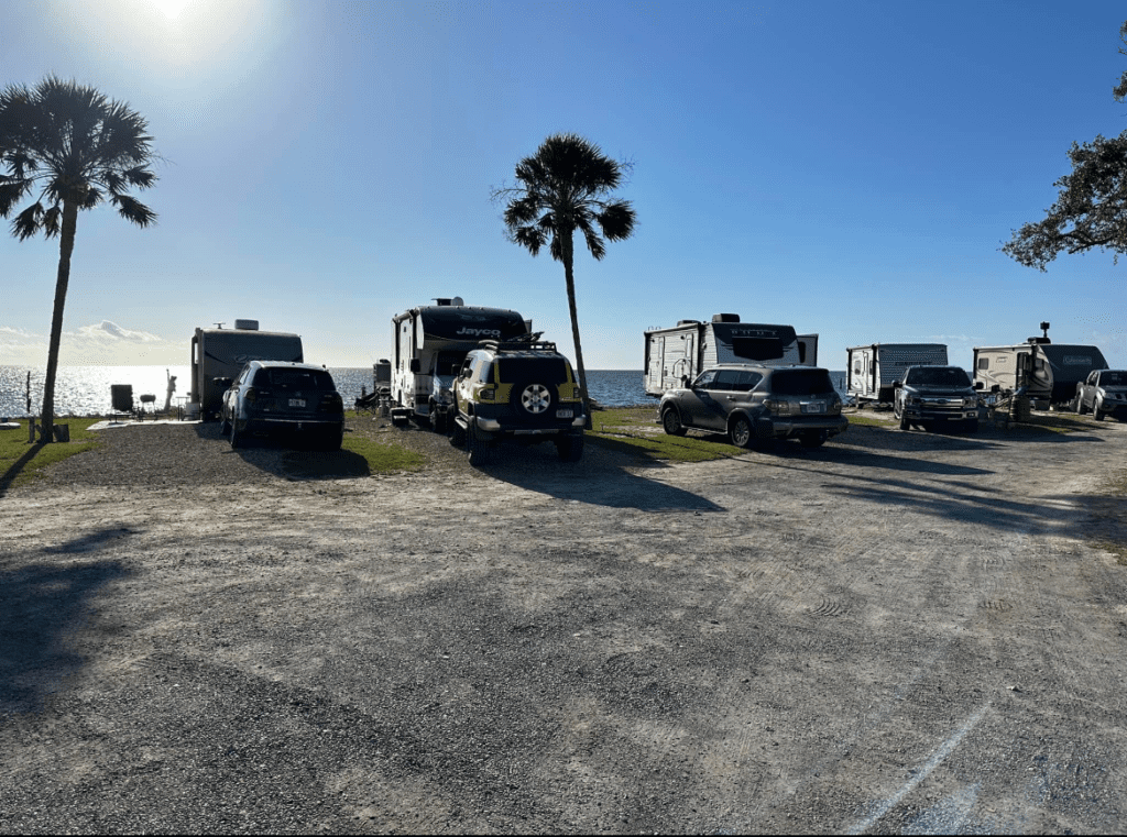 A Group of Vehicles Parked Near on the Beach