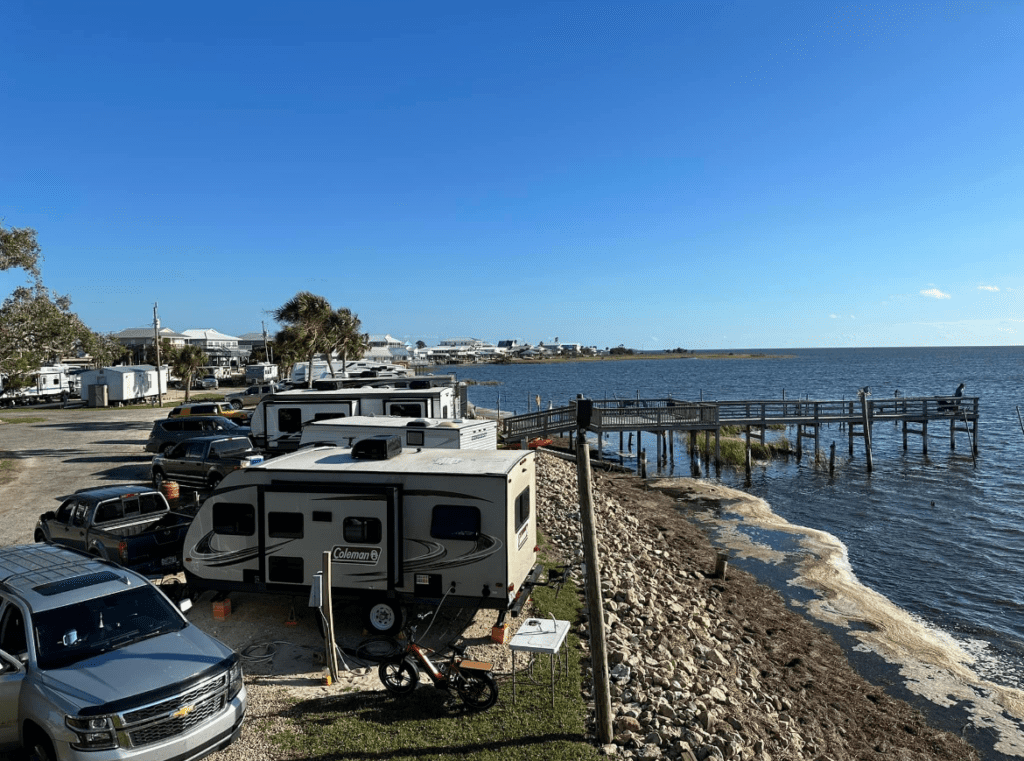 A Group of Cars Parked Next to a Body of Water