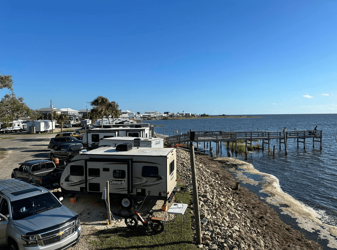 A Group of Cars Parked Next to a Body of Water